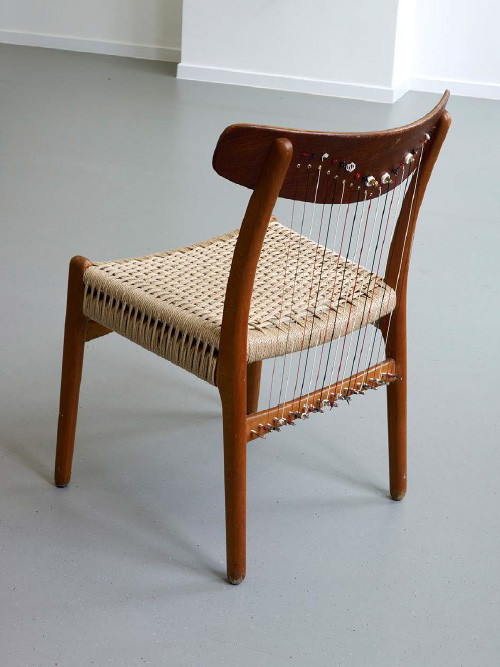 
     <i>Chair Harp (from the series Music Room, Brussels)</i>, 
     2015<br />
     Scandinavian Designer chair from the 70s, teakwood, straw, harp strings, 
      75 x 52 x 50 cm<br />
     